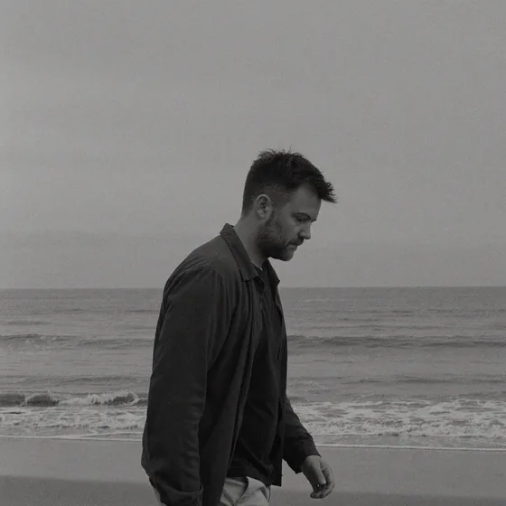 Darren Walker walking on a beach
