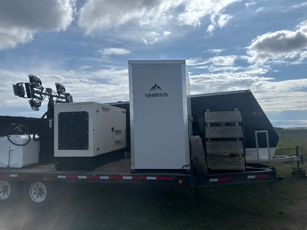A Nash Services combo trailer with light tower, generator and office unit under a prairie sky