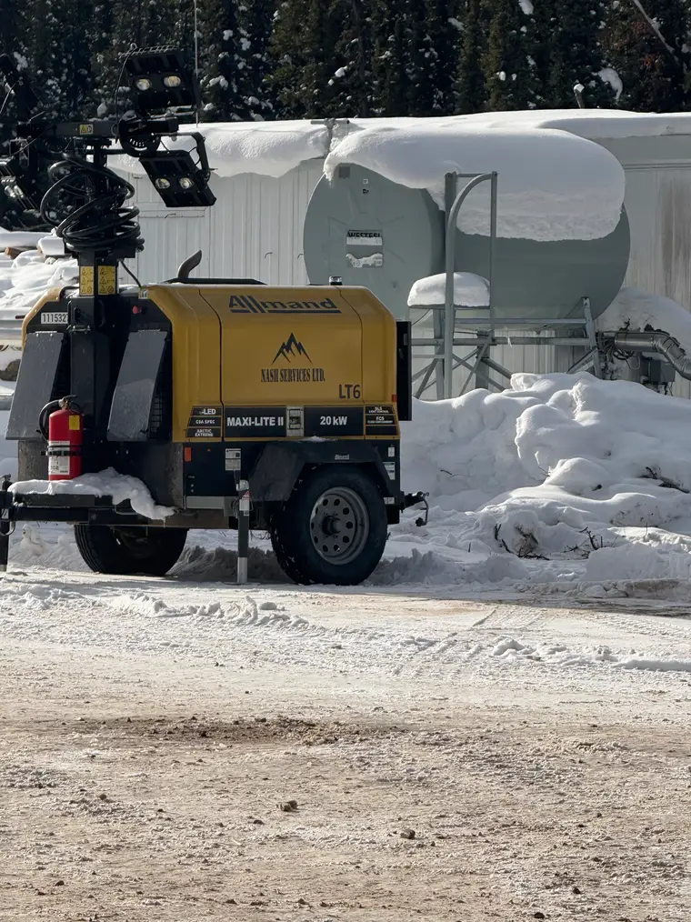 A Nash Services 20kW Allmand LED light tower on a snowy lease site