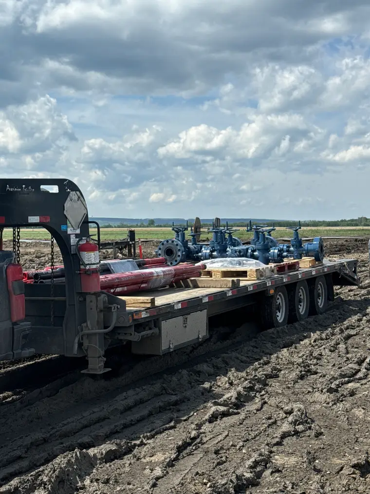 Pipe racks and valves loaded on a Nash Services deck trailer