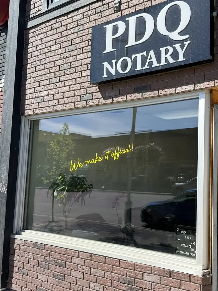 The PDQ Notary sign above the office window, with gold lettering on the glass