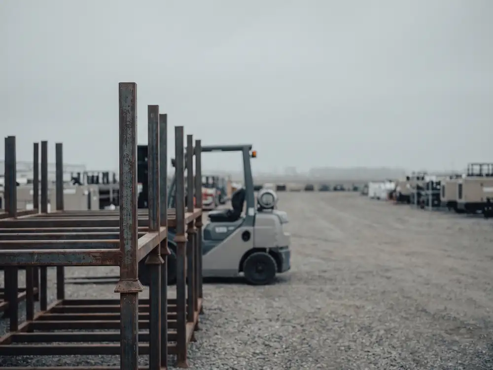 Steel pipe racks and rental equipment lined up in a yard